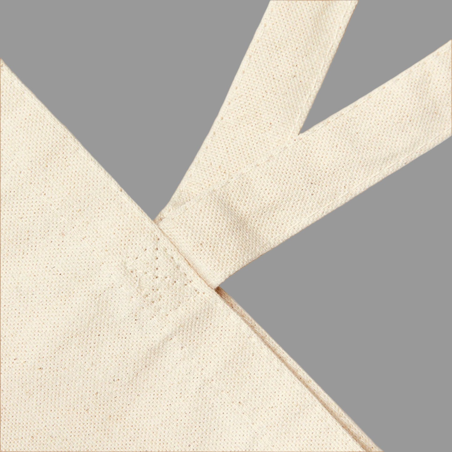 Close-up of beige fabric with a cross pattern on a white background