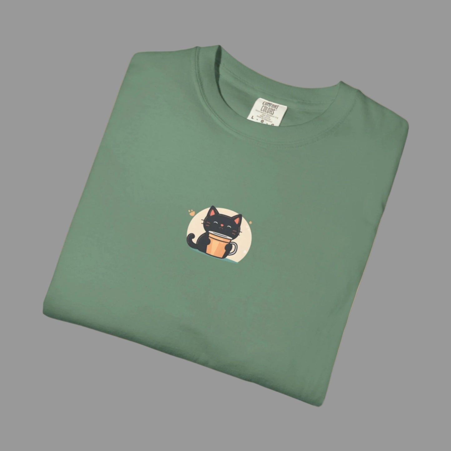 Folded green t-shirt with a cat graphic on a white background
