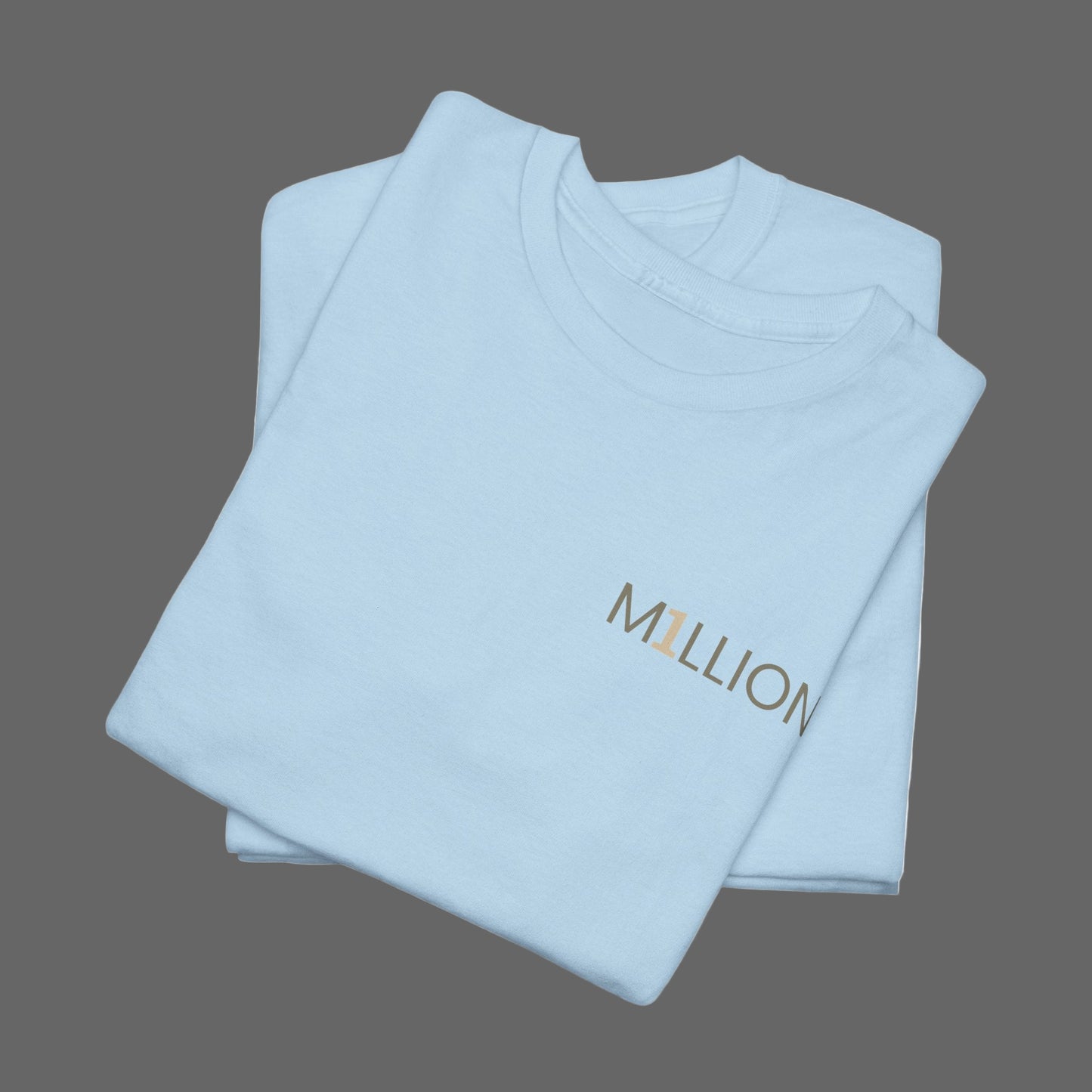 Folded light blue t-shirt with 'MILLION' text on a white background