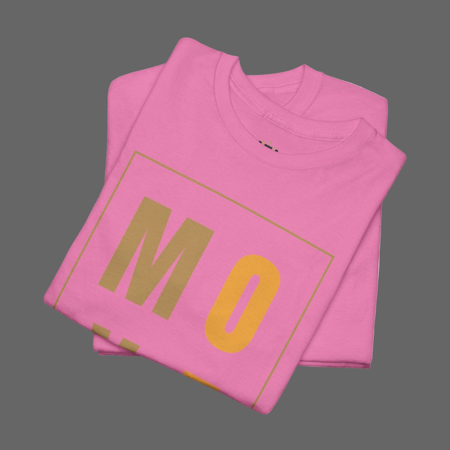 Pink t-shirt with 'MO' printed on it, folded and displayed against a white background