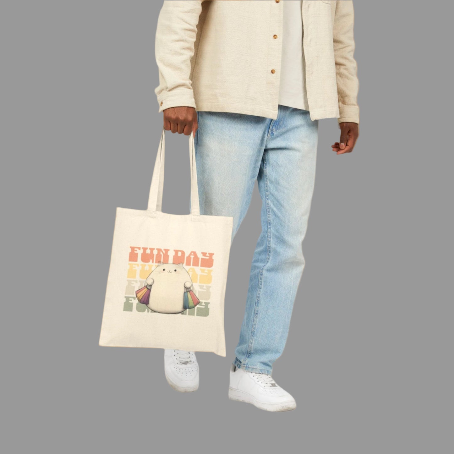 Person holding a tote bag with a cartoon character and text on a white background