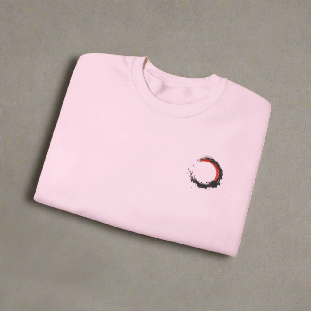 Folded pink sweatshirt with a small design on a white background