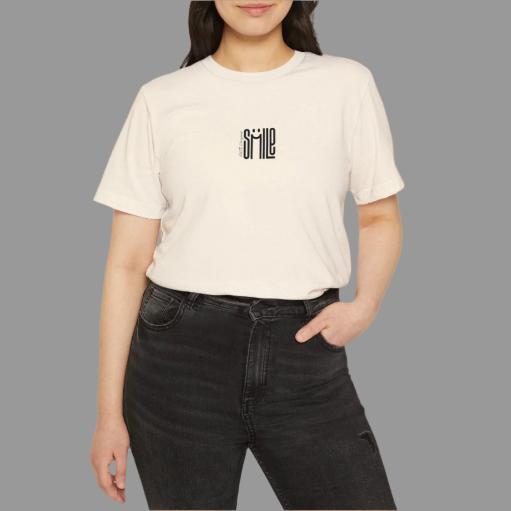 Person wearing a beige t-shirt with a logo on a white background