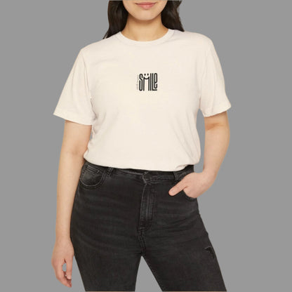 Person wearing a beige t-shirt with a logo on a white background