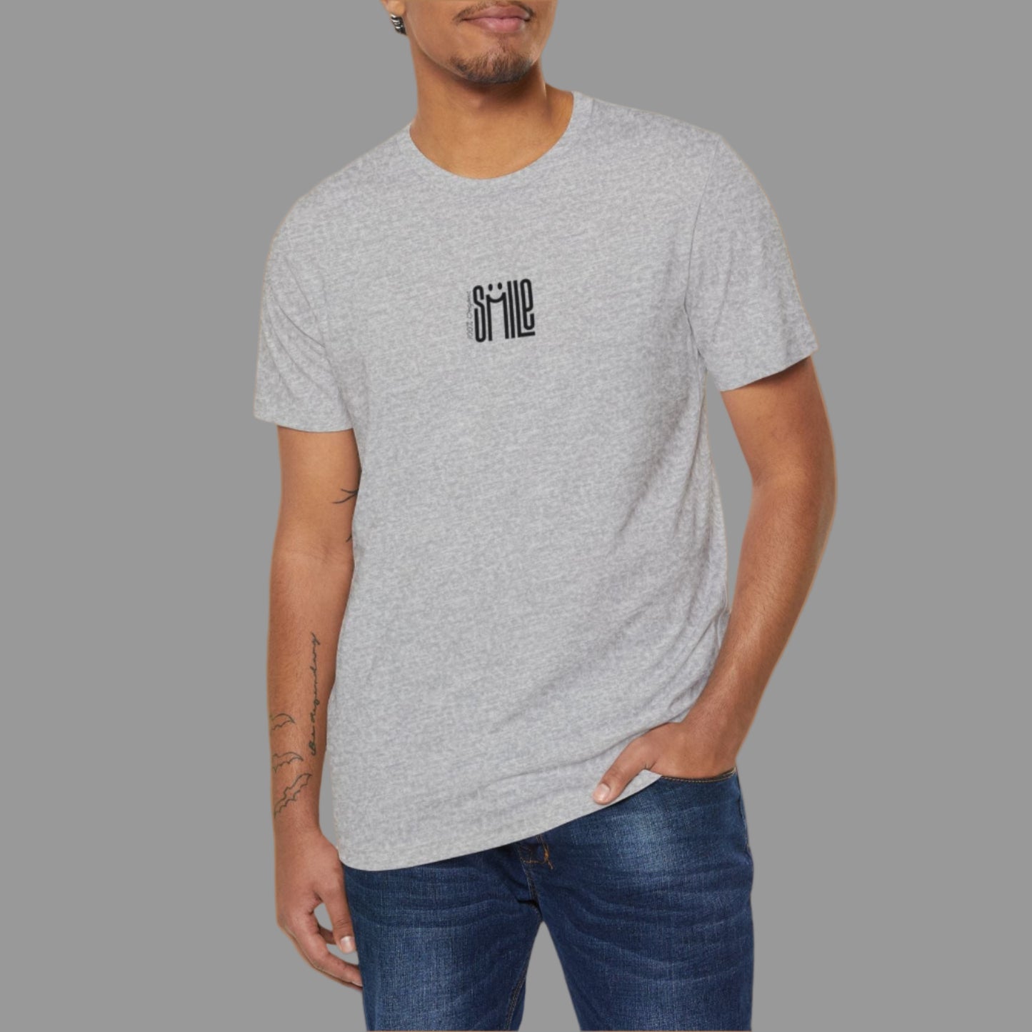 Man wearing a gray t-shirt with a logo on a white background