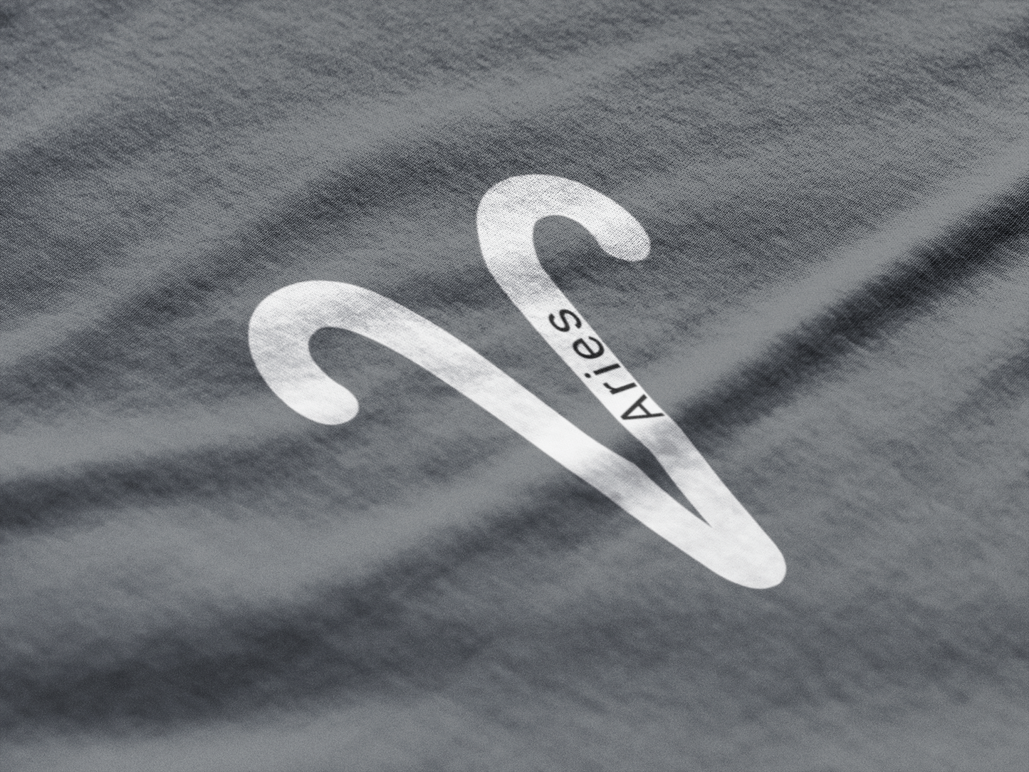 White Aries symbol on a gray t-shirt