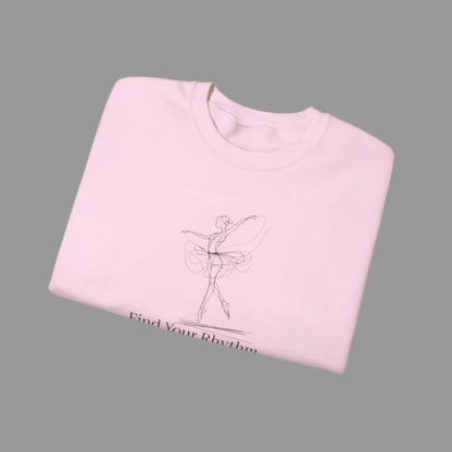 Folded pink sweatshirt with a graphic of a dancer and text 'Find Your Rhythm' on a white background