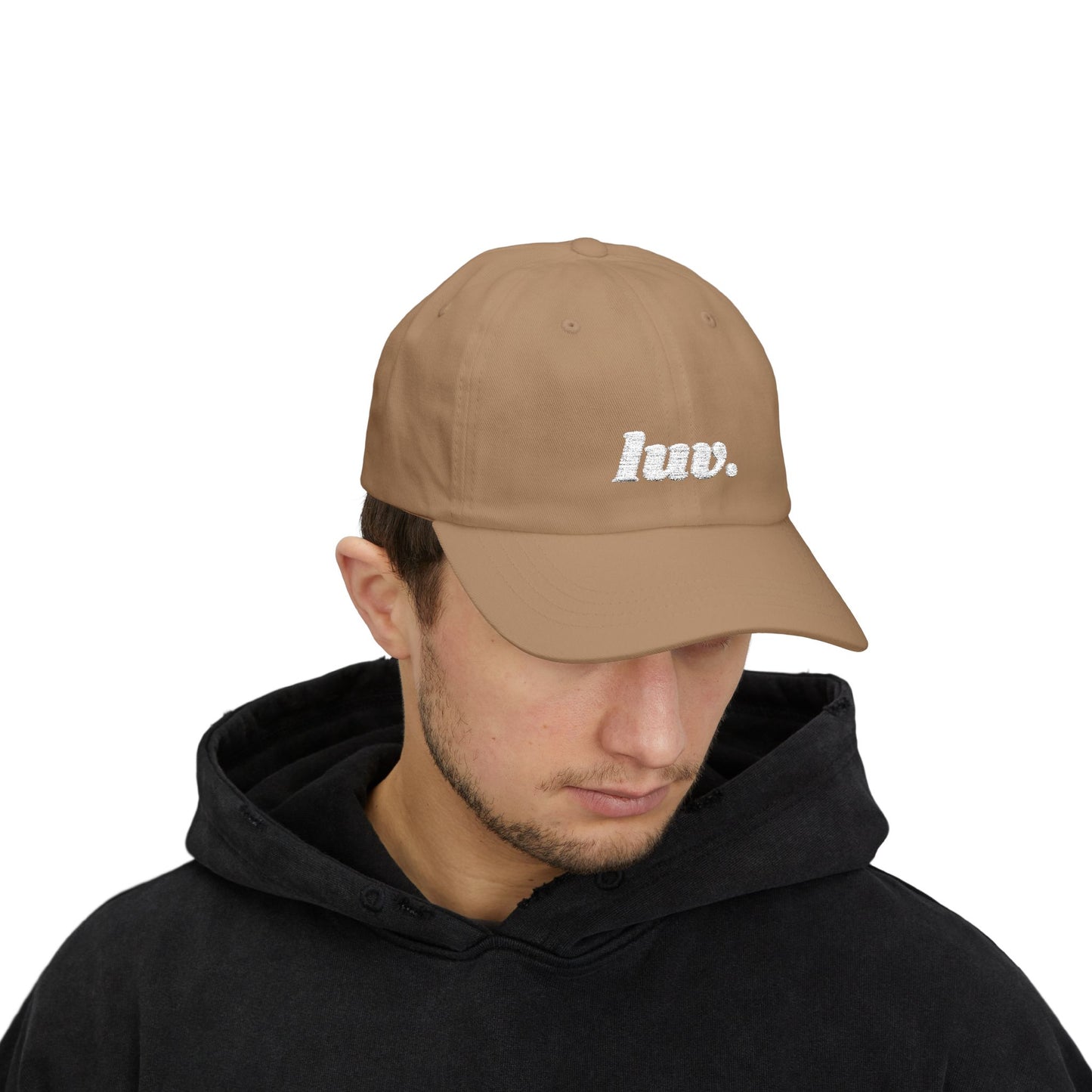 Man wearing a brown cap with 'huv.' logo on a white background