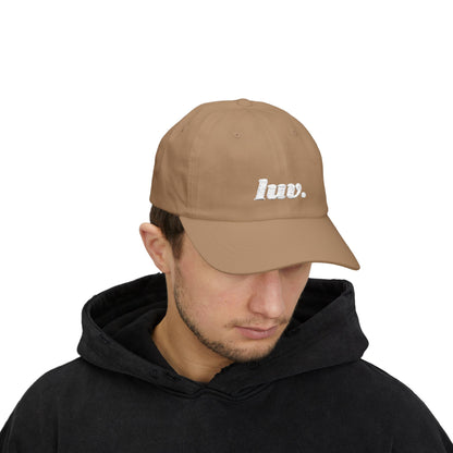 Man wearing a brown cap with 'huv.' logo on a white background