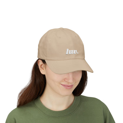 Woman wearing a beige cap with 'hiv.' text on a white background