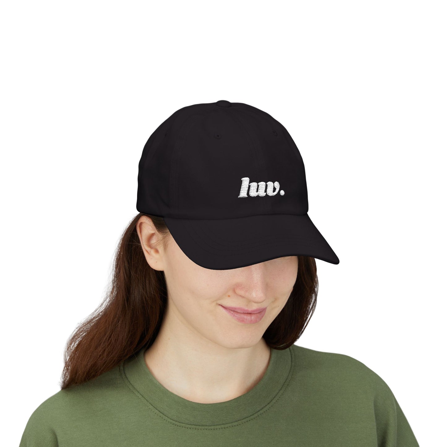 Woman wearing a black cap with 'luv.' text on a white background