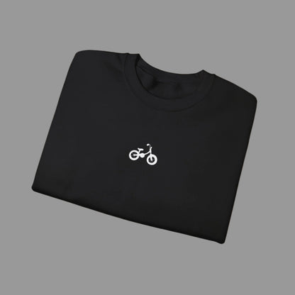 Folded black sweatshirt with a white bicycle logo on a white background
