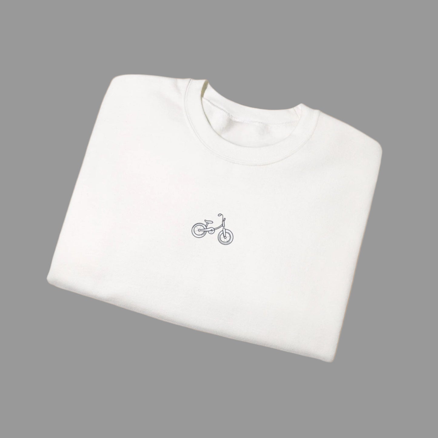 White t-shirt with a small bicycle logo on a white background