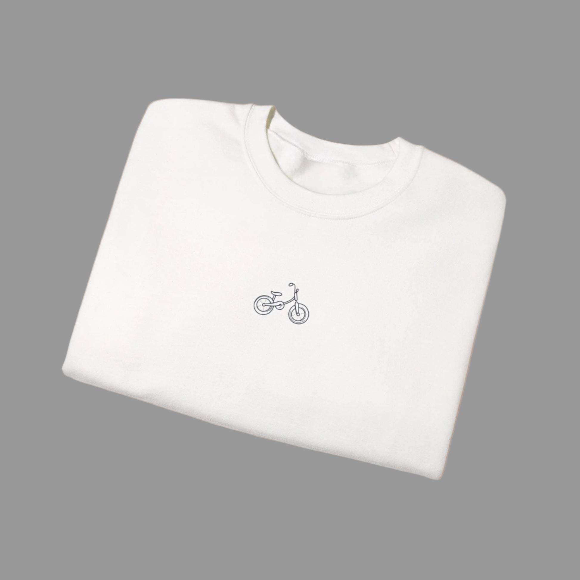 White t-shirt with a small bicycle logo on a white background