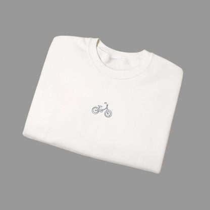 White t-shirt with a small bicycle logo on a white background