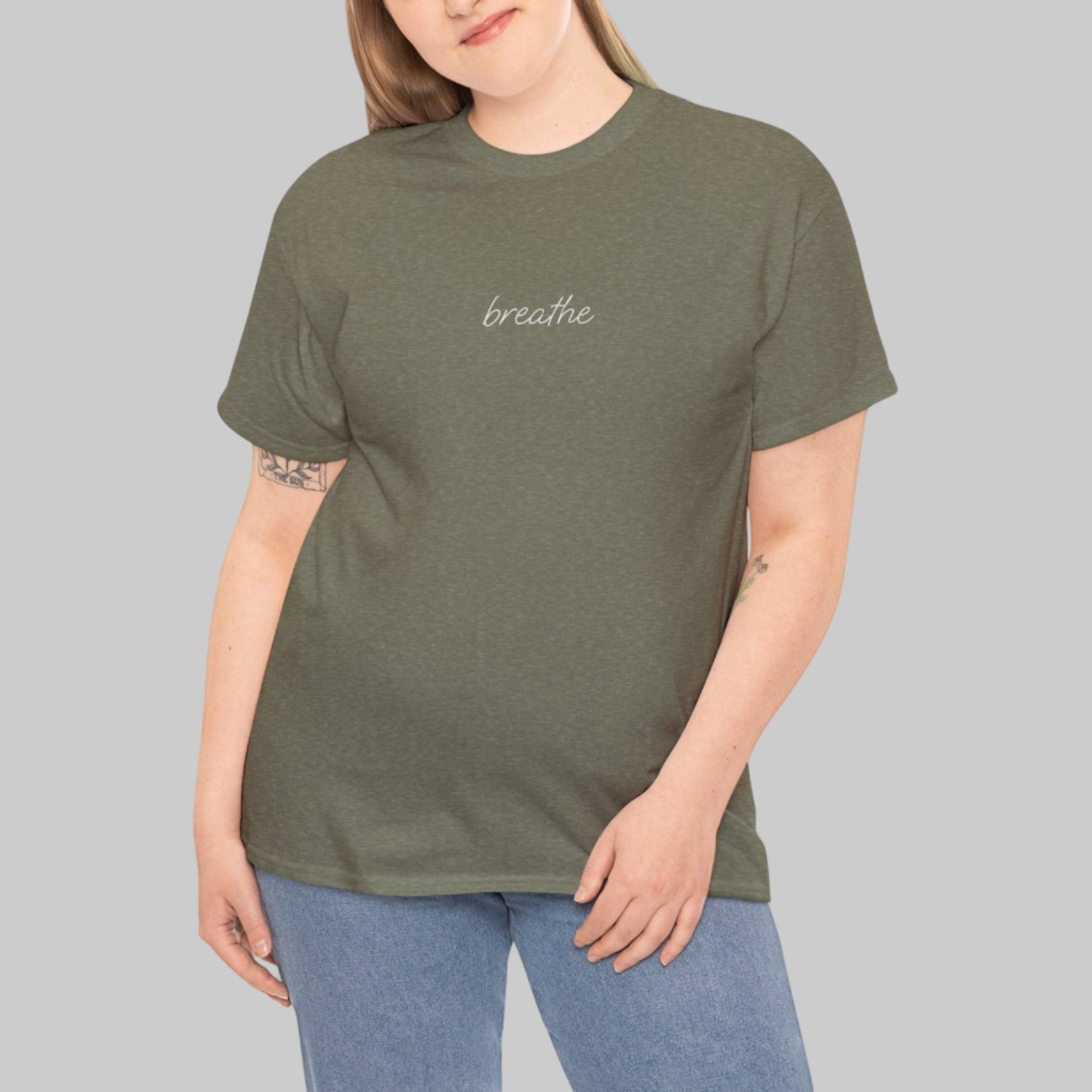 Woman wearing a green t-shirt with 'breathe' text on a white background