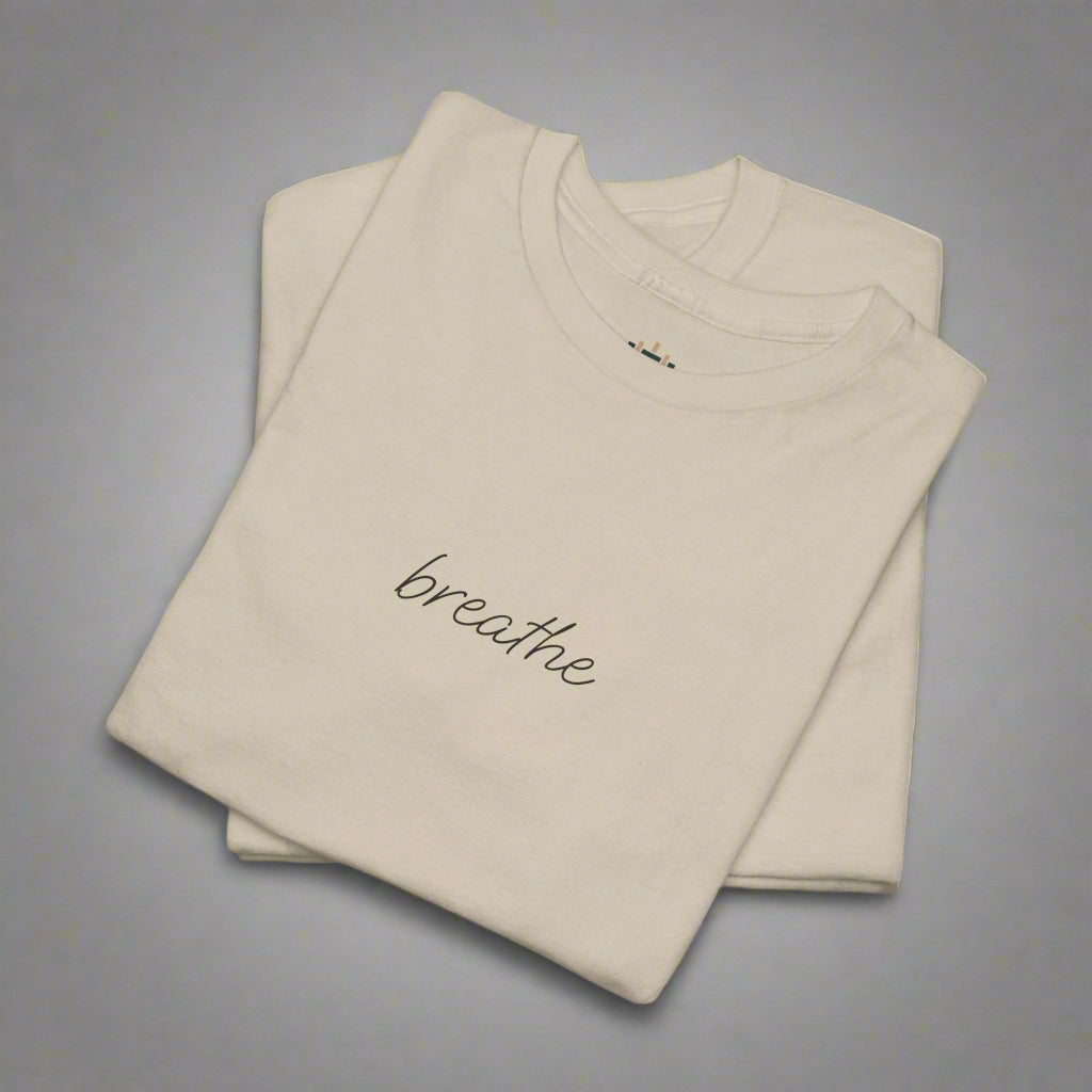 Beige t-shirt with 'breathe' text on a white background