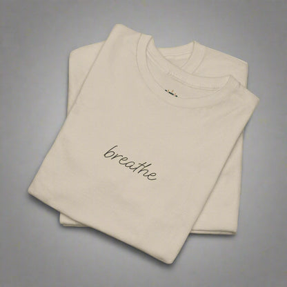 Beige t-shirt with 'breathe' text on a white background