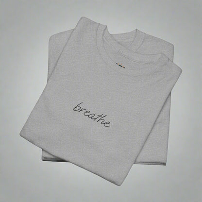 Folded gray t-shirt with 'breathe' text on a white background