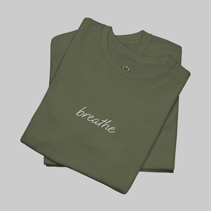 Folded green t-shirt with 'breathe' text on a white background