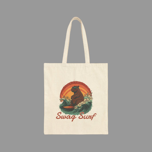 Tote bag with a bear surfing design and 'Swag Surf' text on a white background