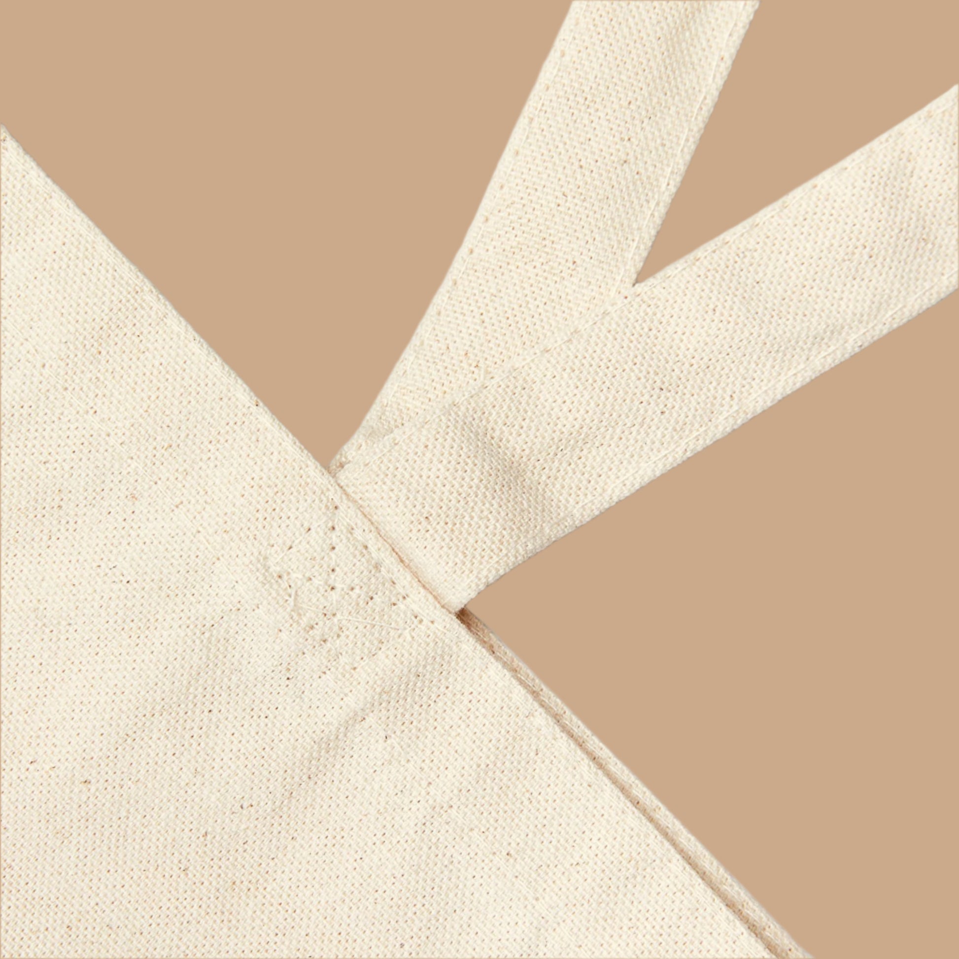 Close-up of beige fabric with a cross pattern on a white background