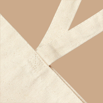 Close-up of beige fabric with a cross pattern on a white background