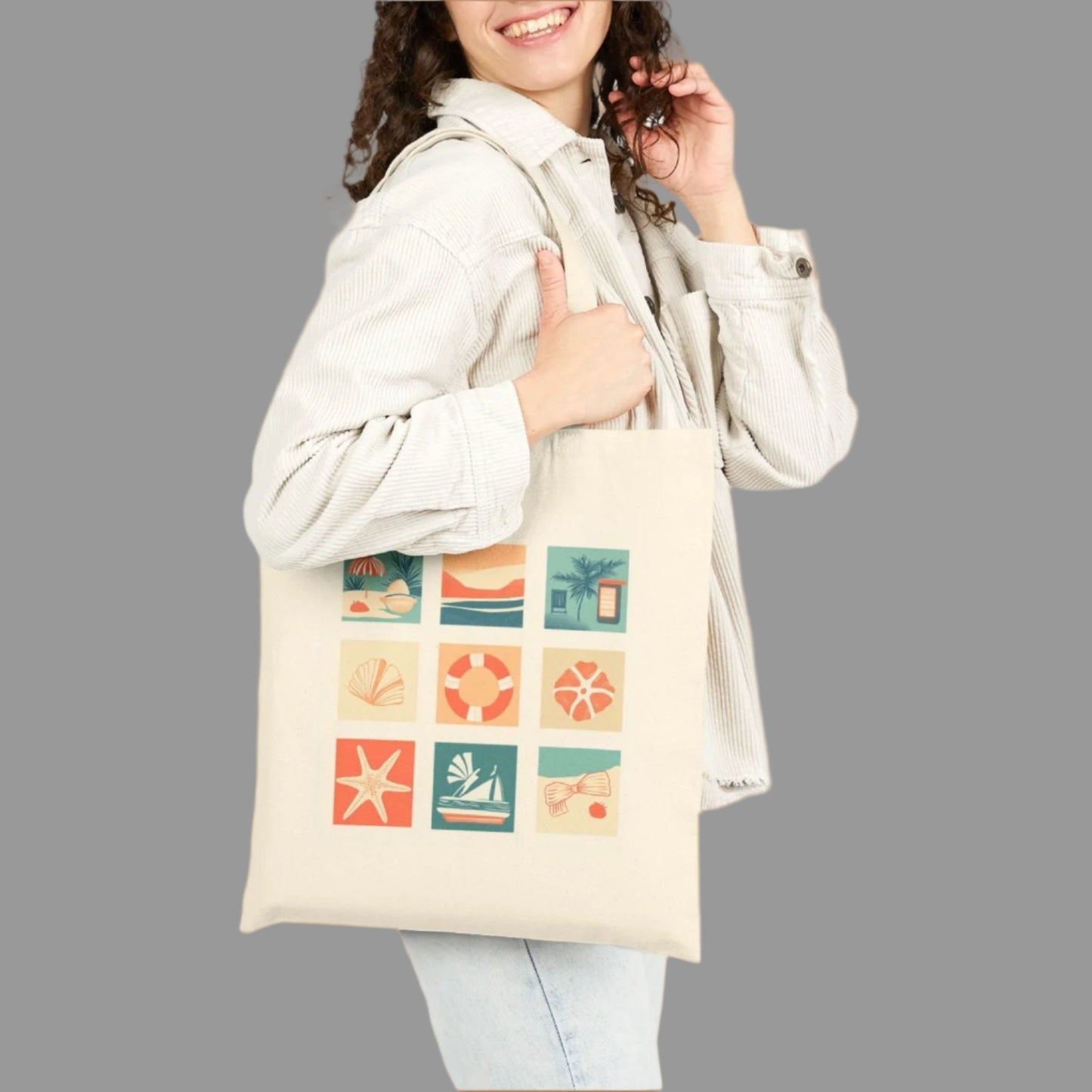 Woman holding a beige tote bag with colorful designs on a white background