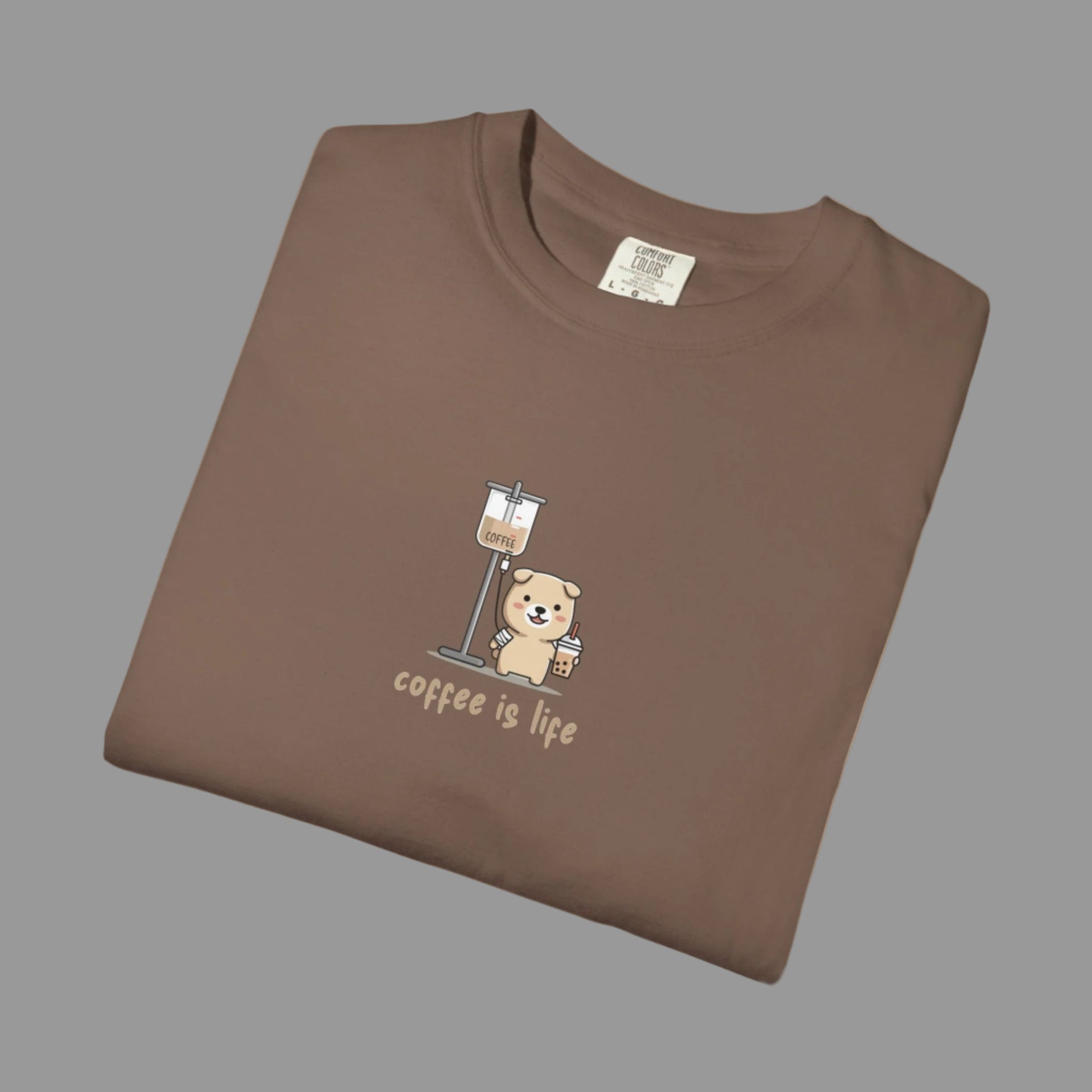 Folded brown t-shirt with a bear and coffee cup graphic and 'coffee is life' text on a white background