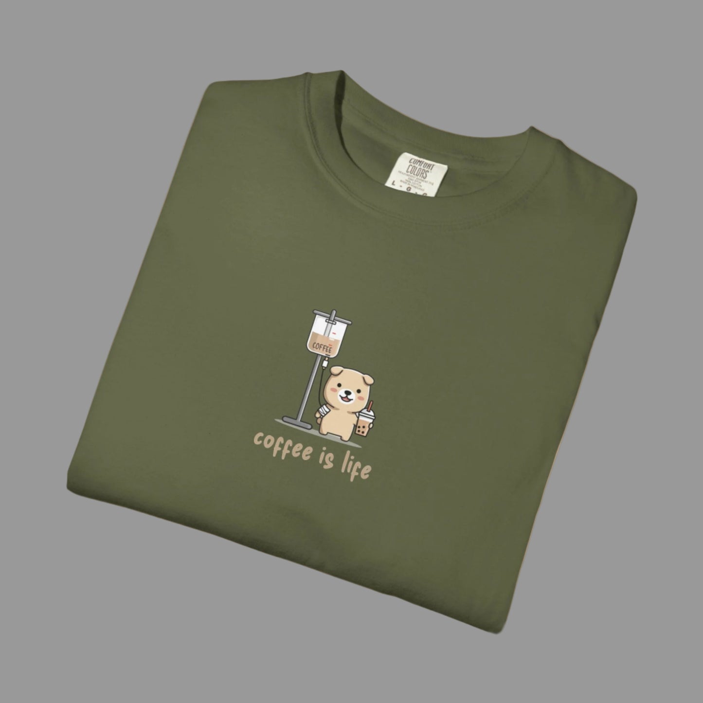 Folded green t-shirt with a bear and coffee cup graphic and 'coffee is life' text on a white background