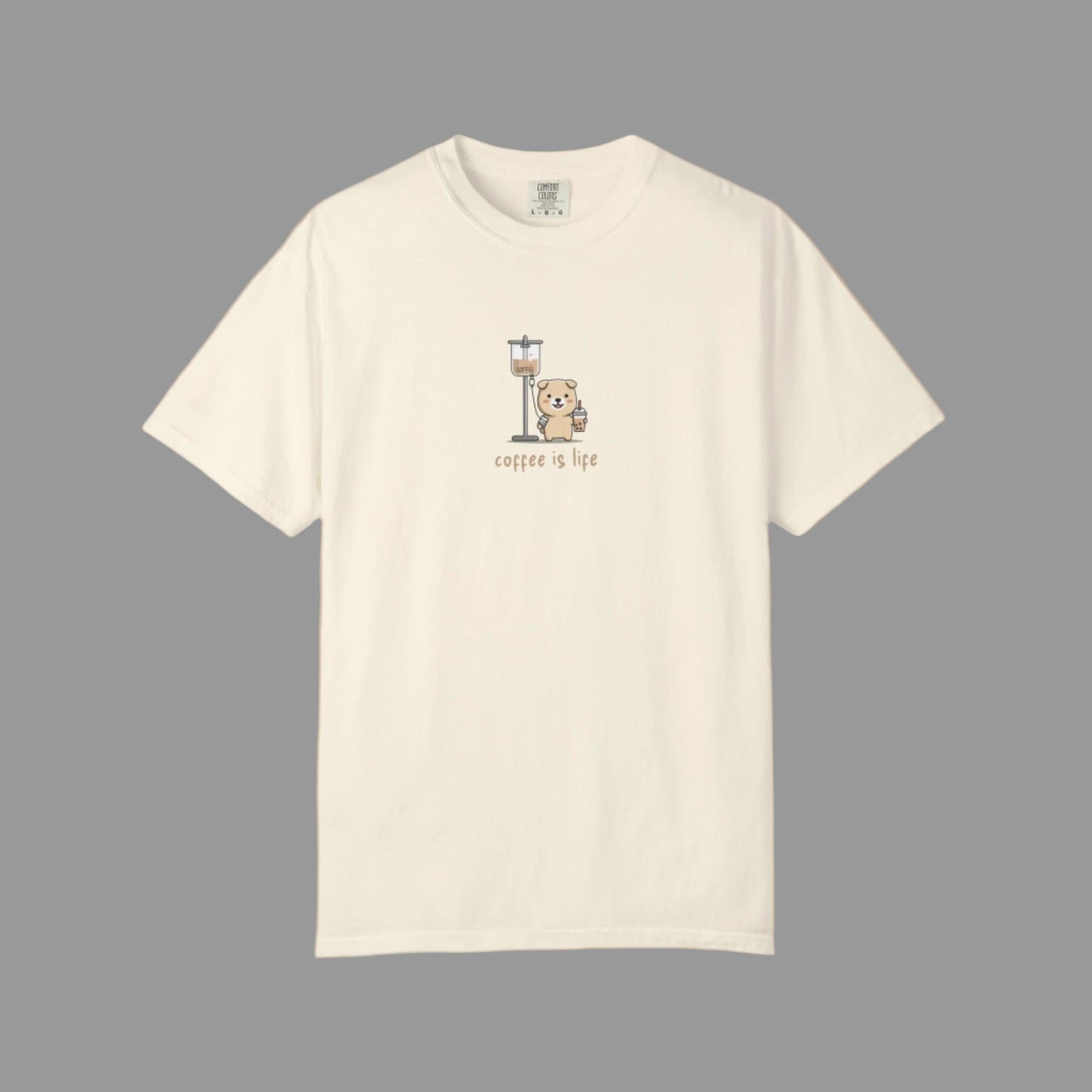 Beige t-shirt with a graphic of a bear holding a coffee cup and 'coffee is life' text on a white background