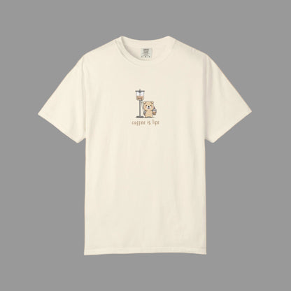 Beige t-shirt with a graphic of a bear holding a coffee cup and 'coffee is life' text on a white background