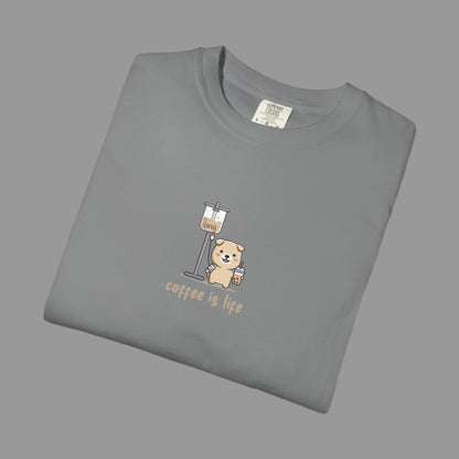 Folded gray t-shirt with a bear and coffee cup graphic and 'coffee is life' text on a white background