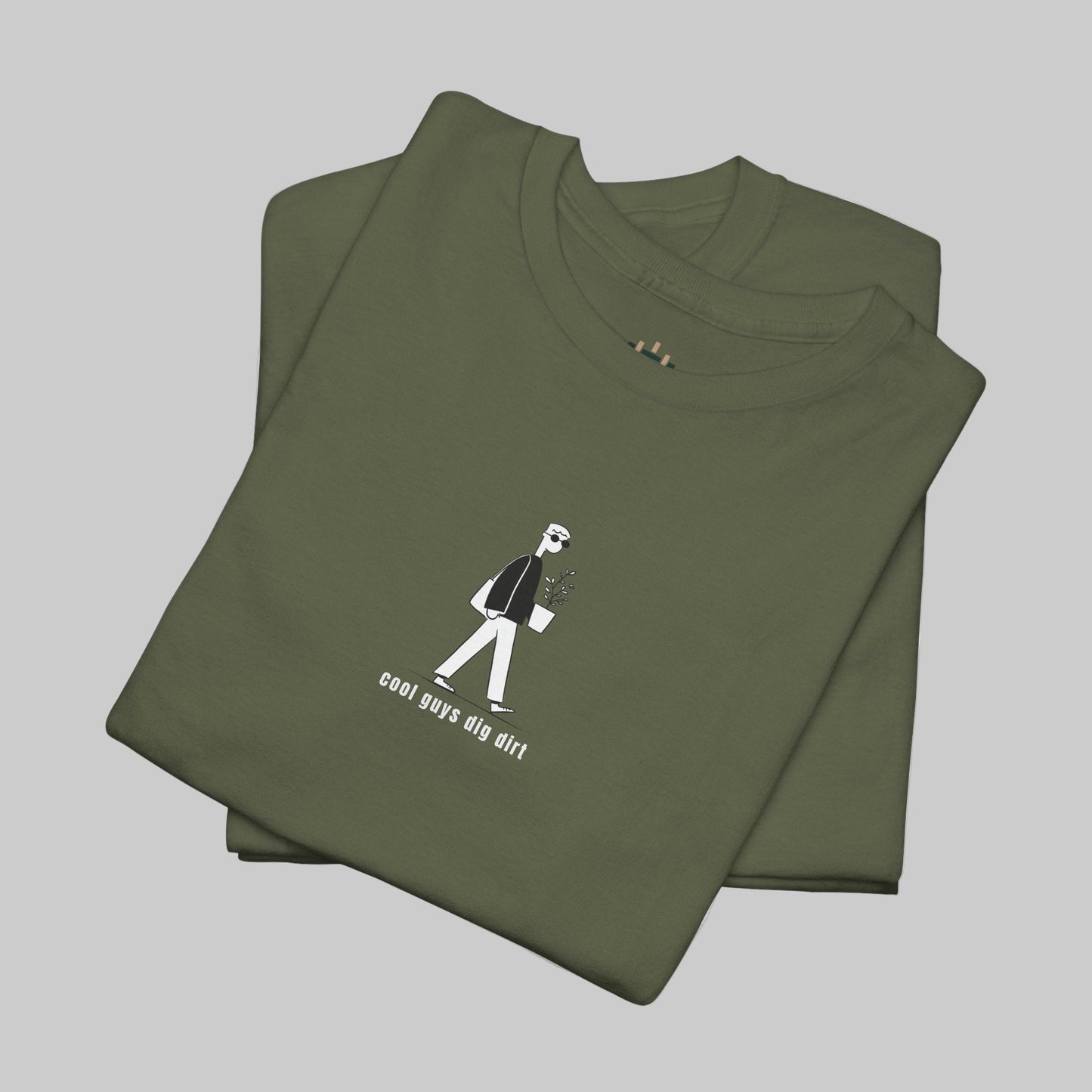 Folded green t-shirt with a graphic design on a white background