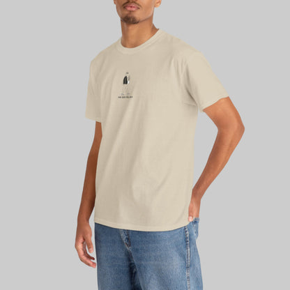 Man wearing a beige t-shirt with a small logo on a white background