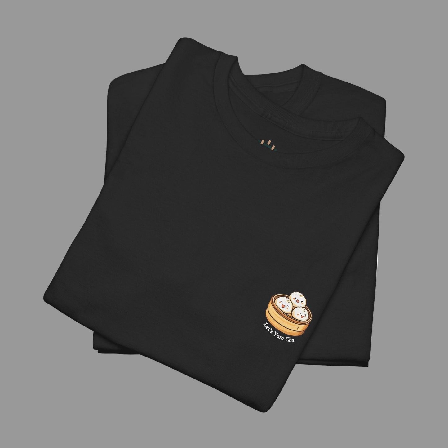 Folded black t-shirt with a logo on the chest against a white background