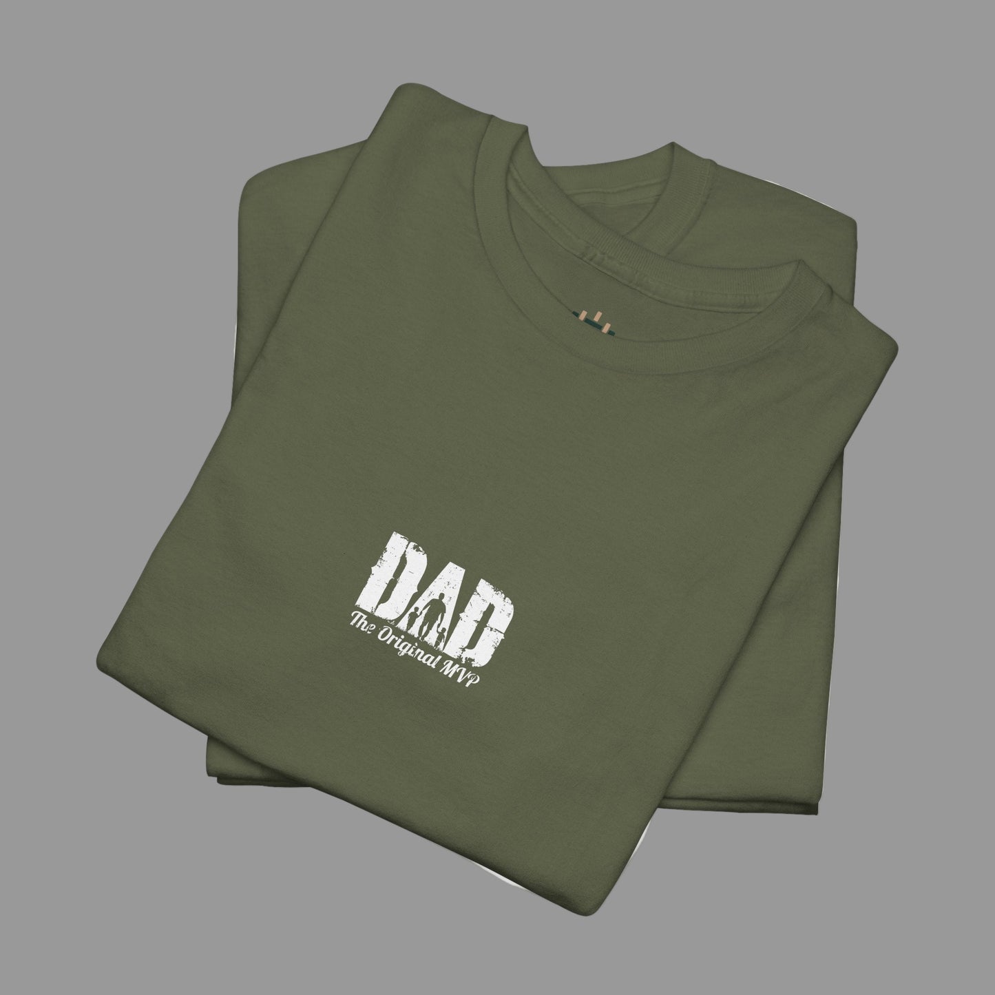 Folded green t-shirt with 'DAD The Original MVP' text on a white background