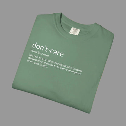 Folded green t-shirt with 'don't-care' text on a white background