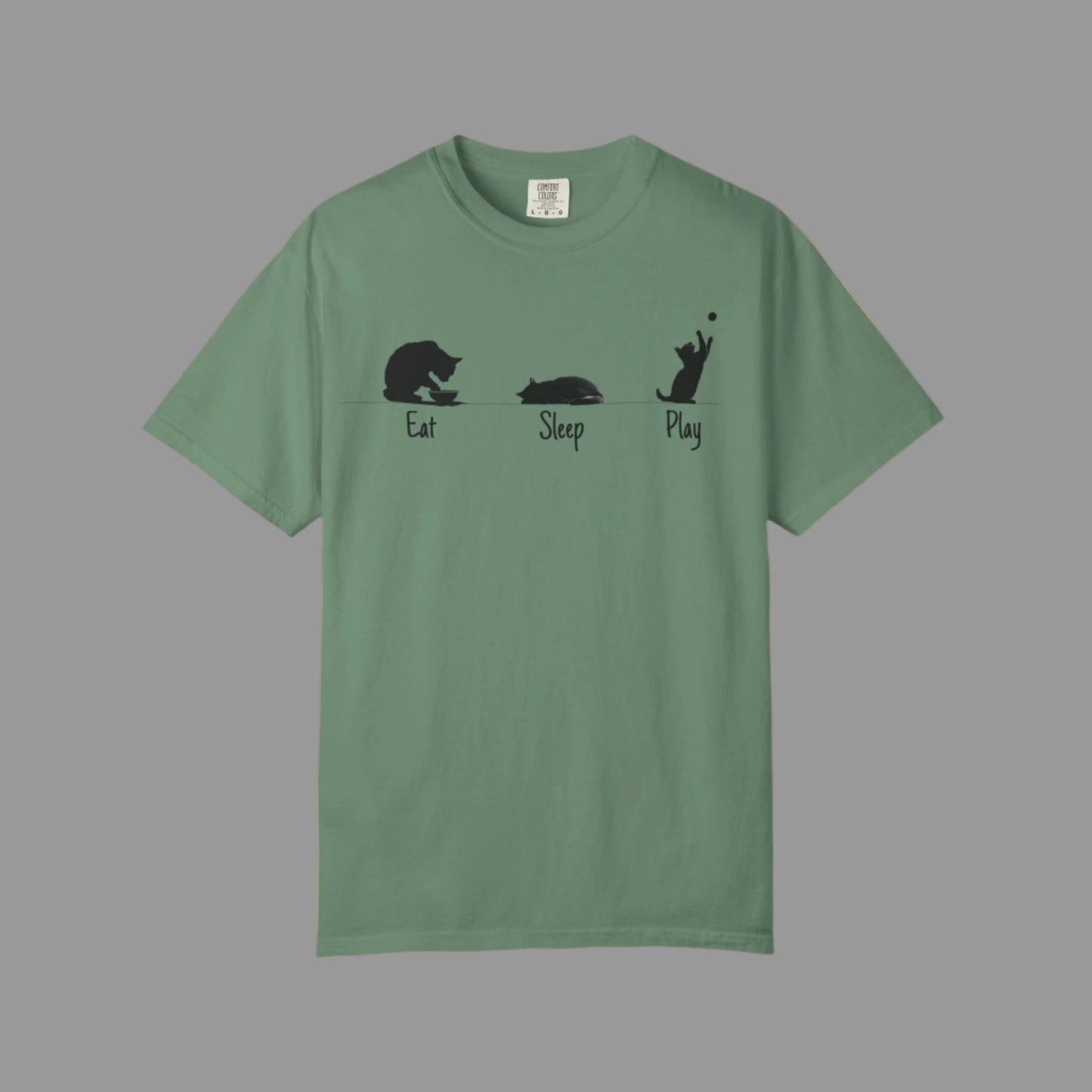 Green t-shirt with black cat illustrations and text on a white background