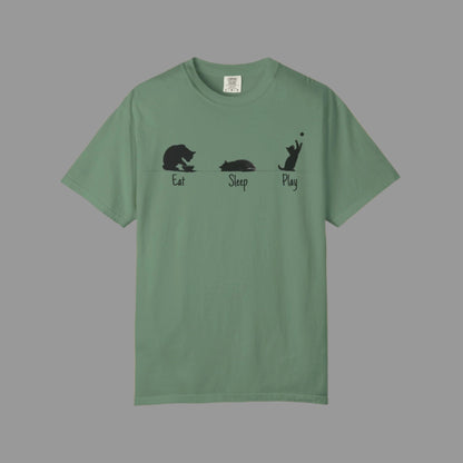 Green t-shirt with black cat illustrations and text on a white background