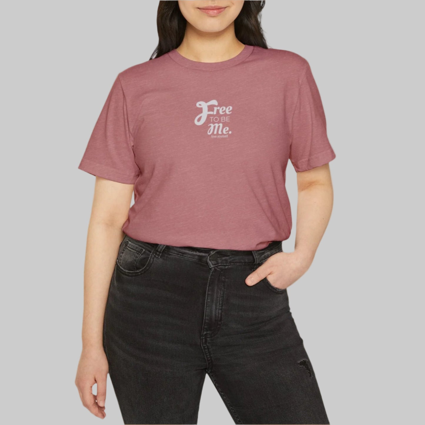 Person wearing a maroon t-shirt with 'Free Me' text on a white background