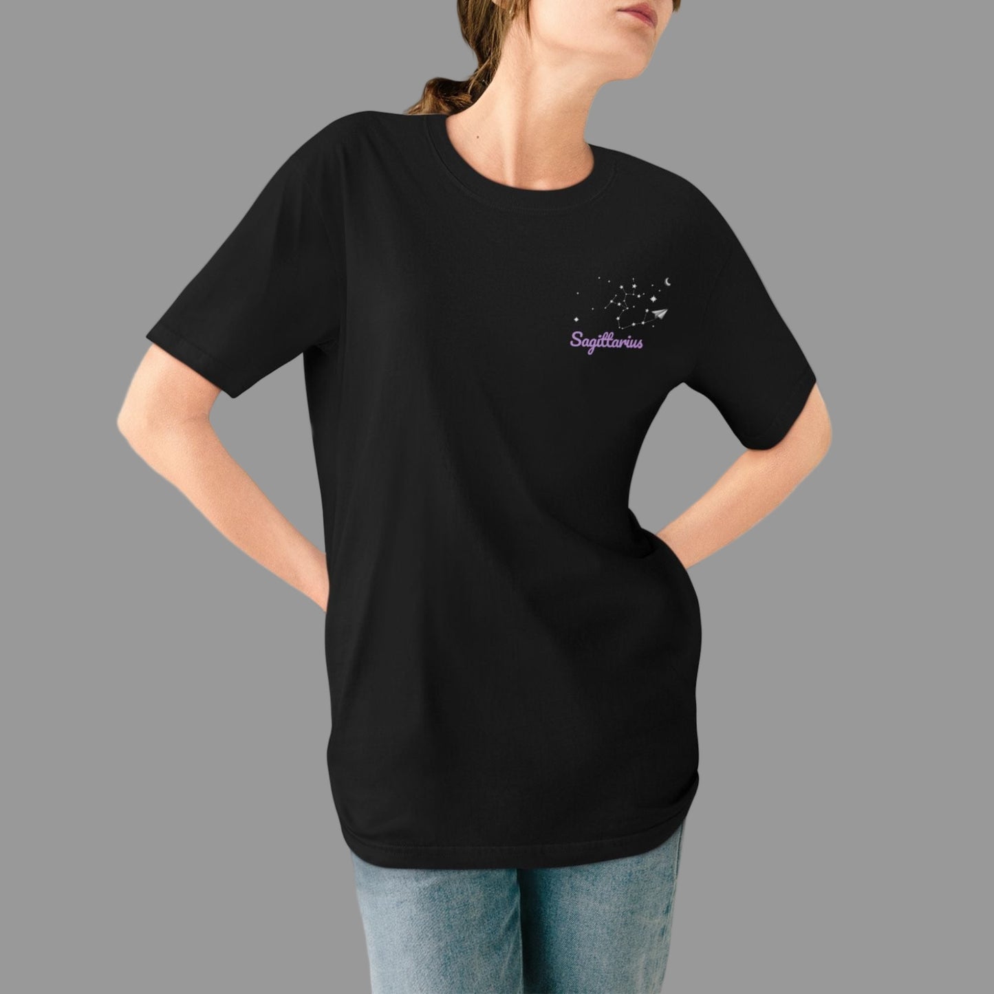 Person wearing a black t-shirt with a small design on a white background