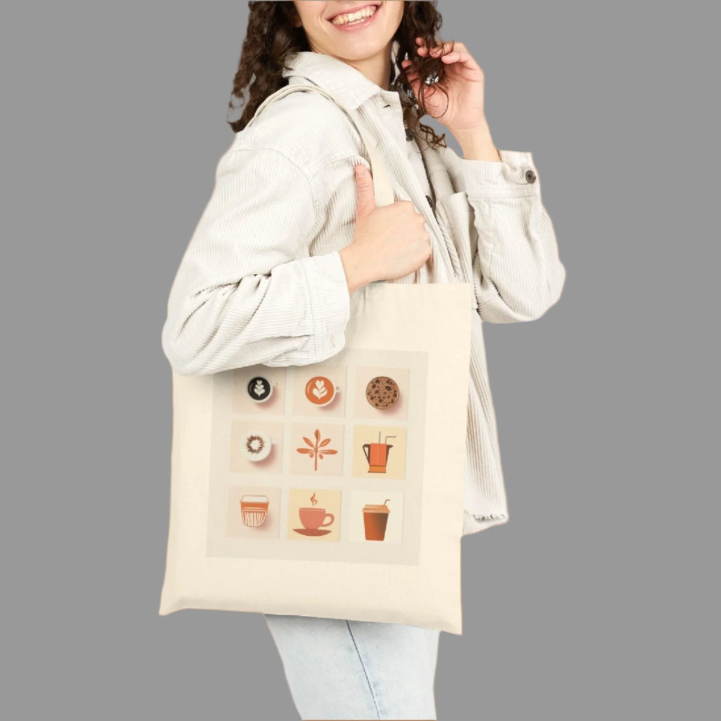 Woman holding a cream-colored tote bag with decorative icons on a white background