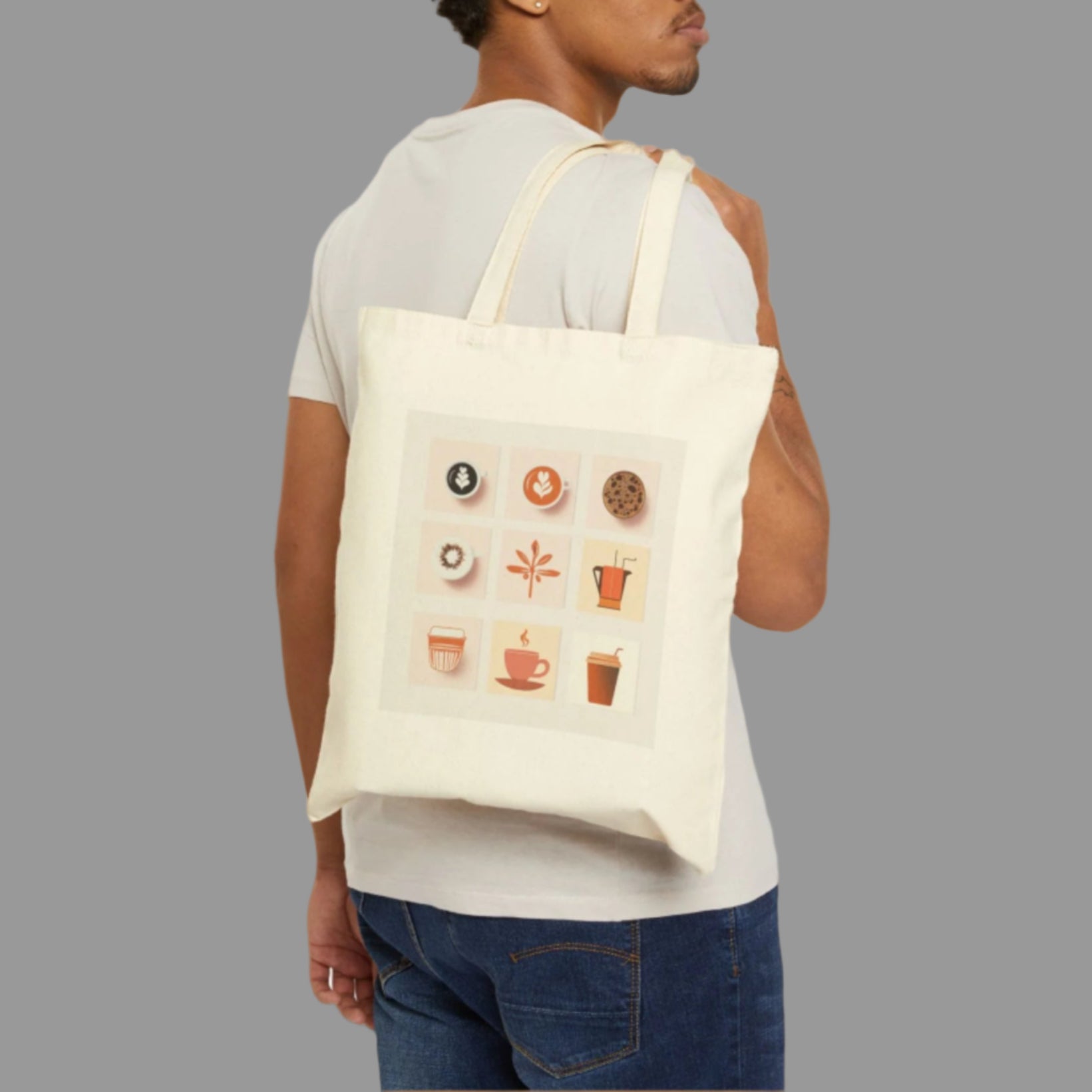 Man wearing a white tote bag with coffee-themed graphics on a white background