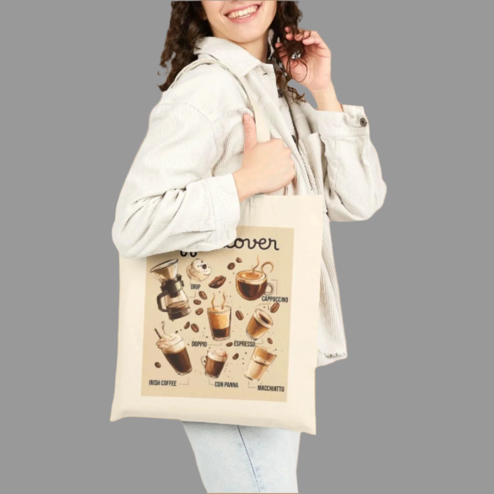 Woman holding a tote bag with coffee-themed design on a white background