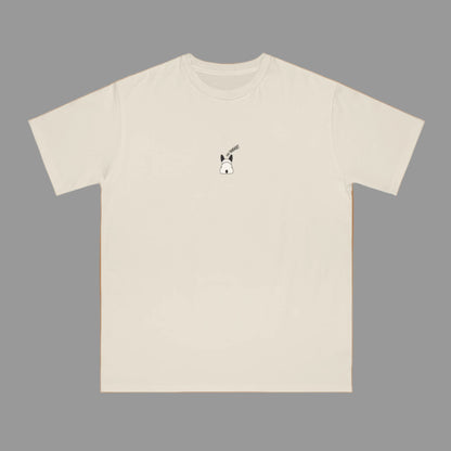 Beige t-shirt with a small dog graphic on a white background