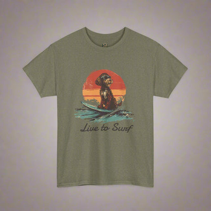 Olive green t-shirt with a graphic of a dog on a surfboard and 'Live to Surf' text, on a white background.
