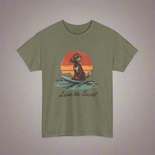 Olive green t-shirt with a graphic of a dog on a surfboard and 'Live to Surf' text, on a white background.