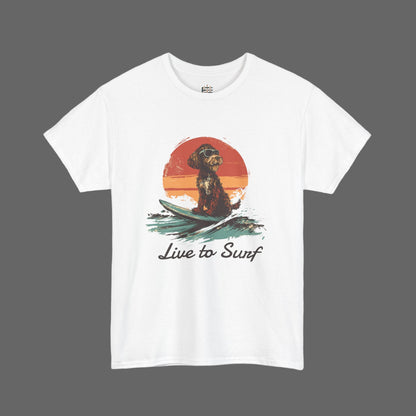 White t-shirt with a graphic of a dog on a surfboard and 'Live to Surf' text, set against a white background.