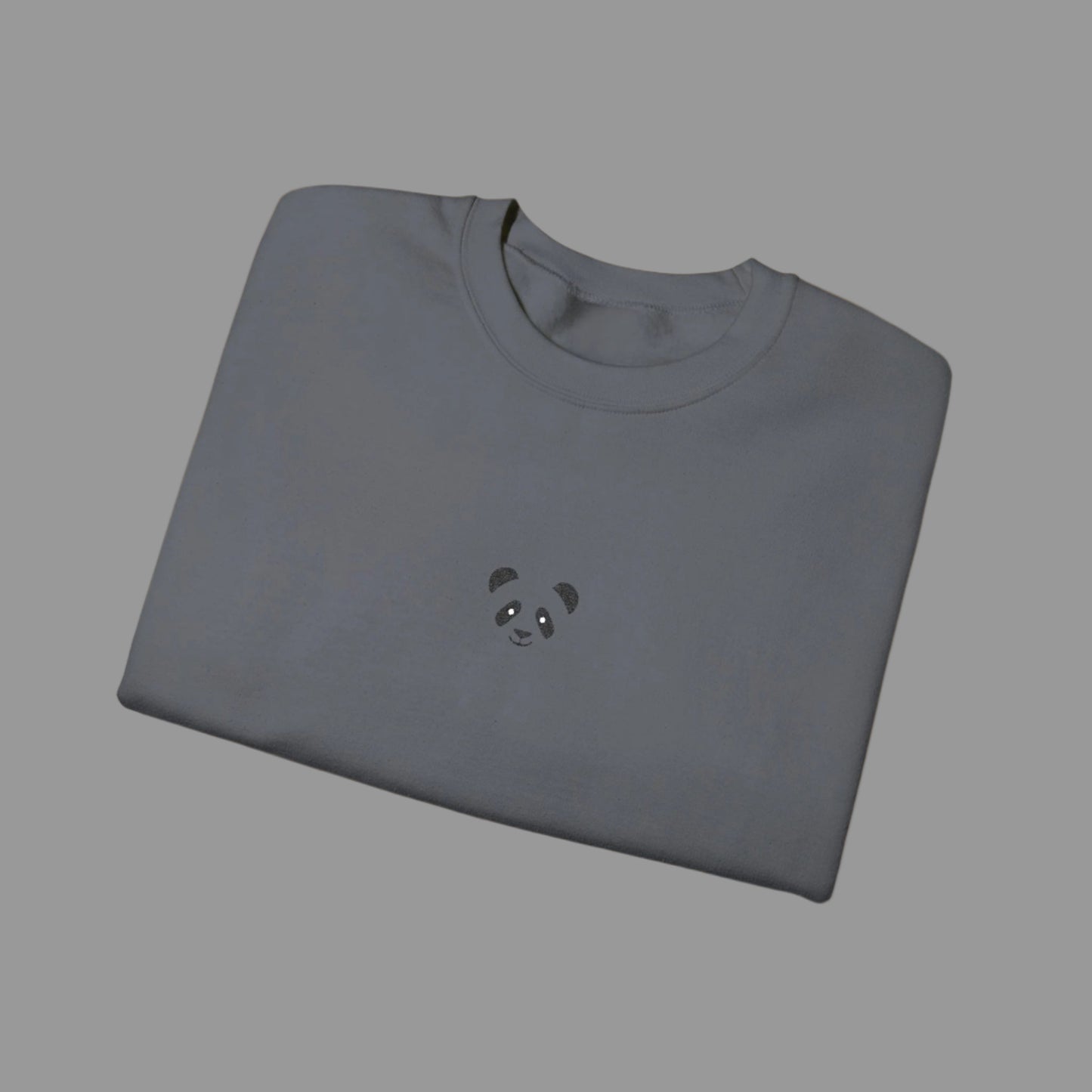 Folded gray sweatshirt with a panda design on a white background